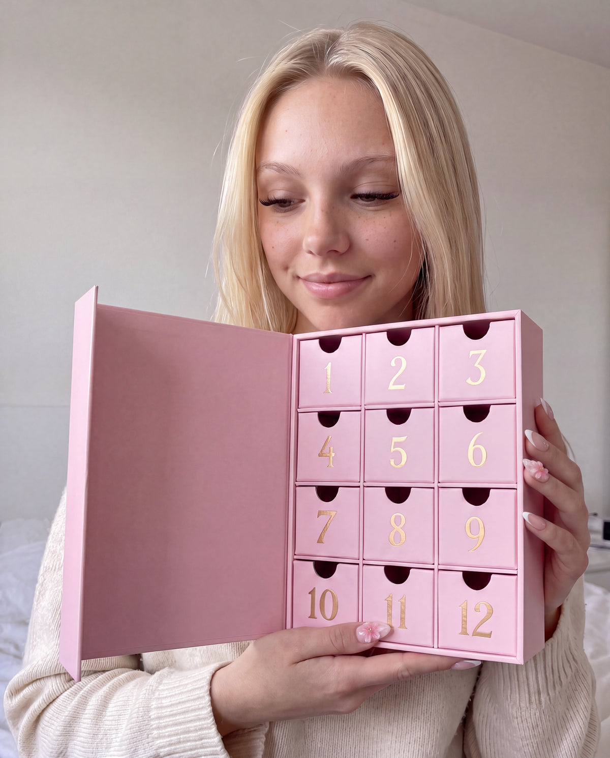 12 cases — Lily avec le calendrier de l'Avent bijoux 12 cases ouvert entre les mains.